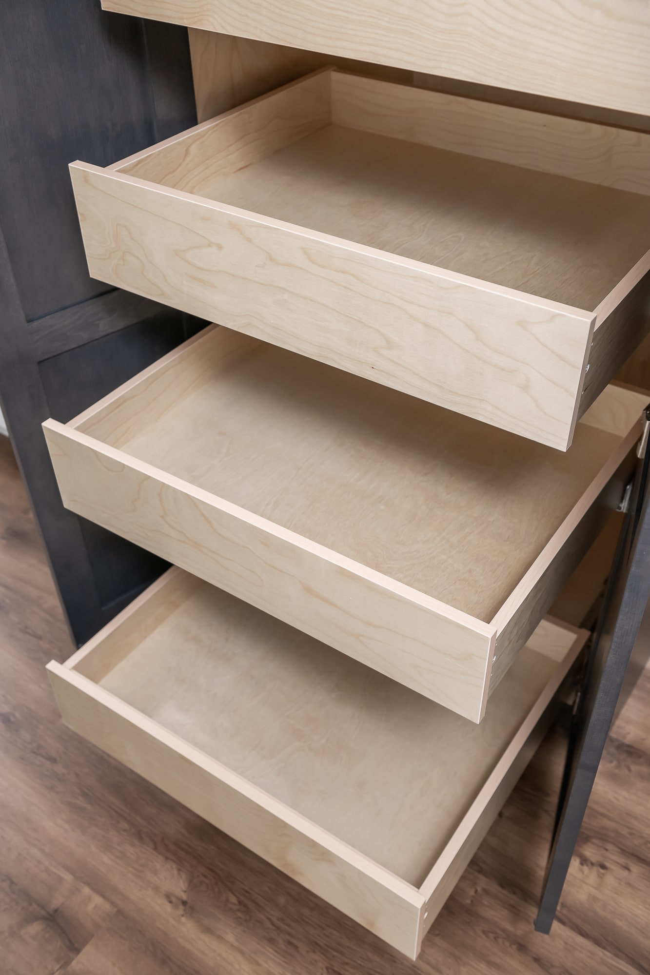 Custom pull-out drawer inserts with natural maple wood finish by Alderidge Construction, demonstrating precision joinery and superior cabinetry construction quality