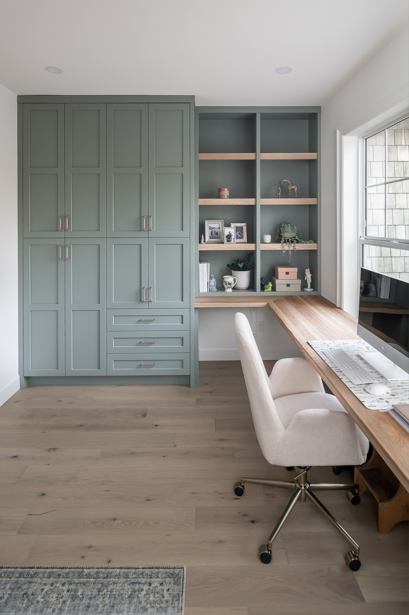 Custom built-in home office with sage green cabinetry and open shelving by Alderidge Construction, offering a stylish and functional workspace solution