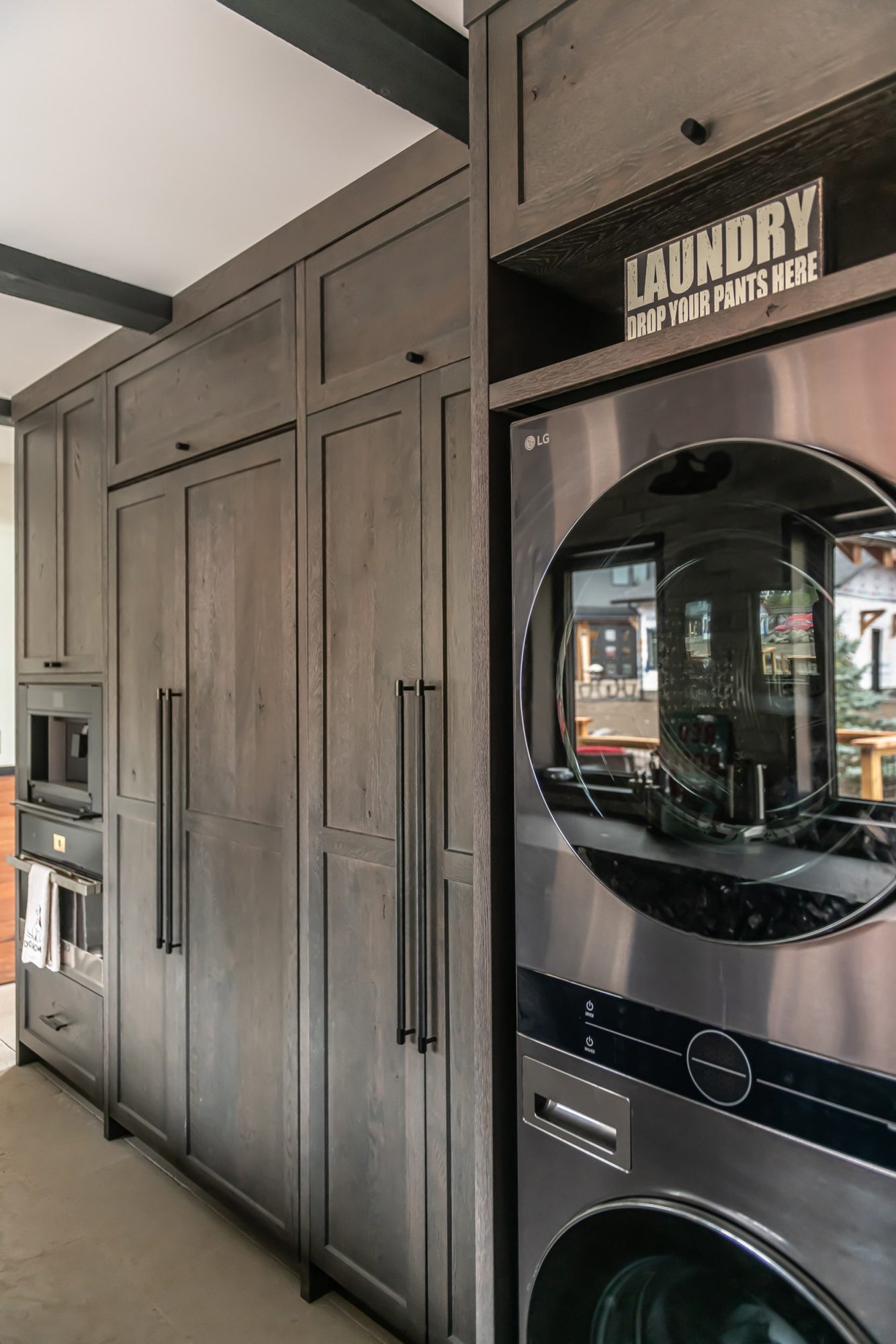 Close-up detail of gray weathered wood cabinet with black bar pull hardware